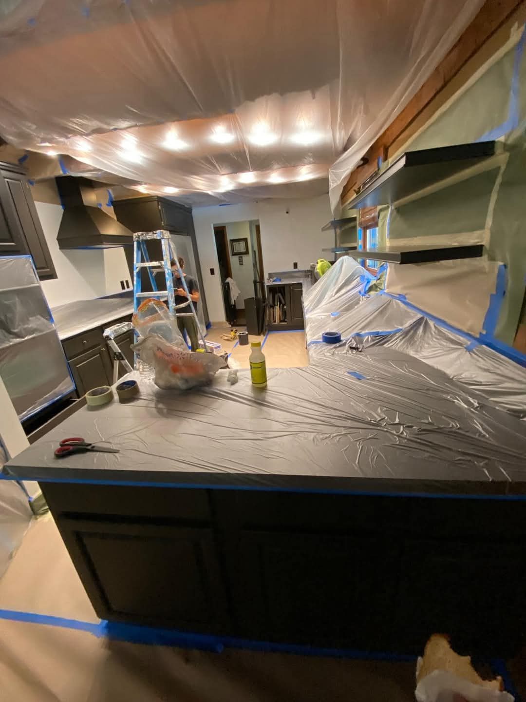 Kitchen cabinetry masked and prepared for finishing